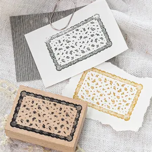 Vintage wooden rubber stamp with intricate lace border and floral pattern for DIY crafts