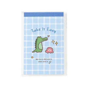 Mini glue-bound notebook featuring a cute cartoon crocodile illustration and blue plaid design