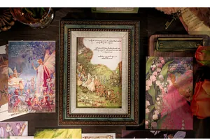Vintage European fairy tale postcards with artistic illustrations on a rustic wooden desk