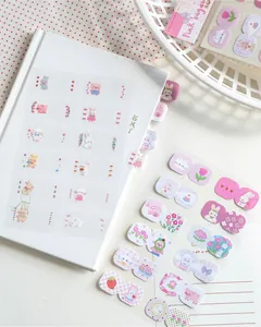 Close-up of cute animal index tabs used on a white notebook for DIY decorative journaling