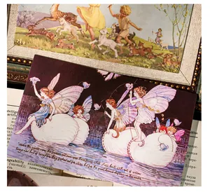 Close-up of vintage European fairy tale postcards featuring hand-drawn illustrations and art