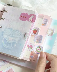 Close-up view of cute cartoon animal index tabs applied to a pastel-colored ring planner
