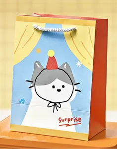 Detail showing a vertical gift bag with cute cartoon cat illustration and Surprise text.
