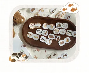Close-up of cute animal index stickers with cat and dog illustrations on a wooden tray.