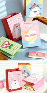 Detail view of colorful vertical paper gift bags with cute animal and food illustrations