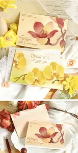 Detailed view of gold foil floral greeting cards featuring original artistic illustrations