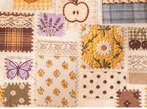 Detailed macro shot of vintage floral embroidery patterns on white kraft paper