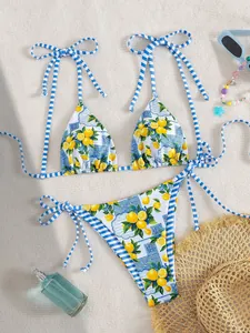 Vibrant two-piece bikini set featuring lemon floral print and nautical blue striped ties