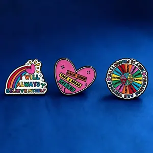 Colorful enamel pins featuring inspirational mental health quotes on a blue background