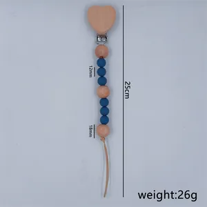Detailed view of handmade silicone and beech wood pacifier clip showing 25cm total length