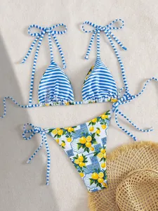 Detailed look at two-piece bikini featuring blue stripes and fresh lemon patterns
