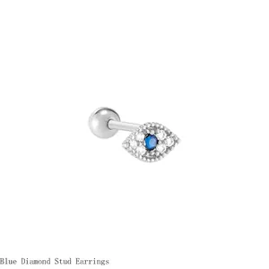 Detailed macro view of silver Evil Eye stud earring with blue and white crystals