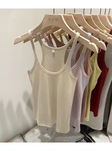 Detail view of slim fit ribbed knit tank tops in multiple colors hanging on a rack