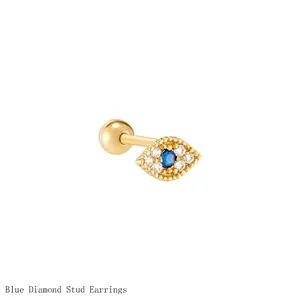 Detailed view of a gold Evil Eye stud earring with pavé white zircons and blue center stone.