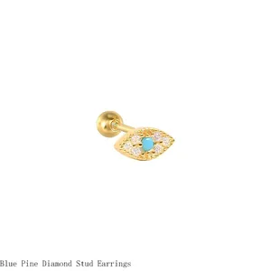 Detail of evil eye stud earring with turquoise and diamonds in gold