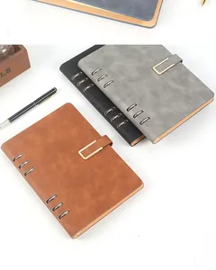 Close-up of A5 loose-leaf business notebooks with PU leather covers in multiple colors