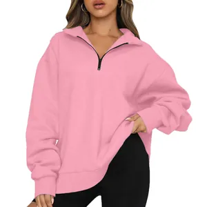 Frontal view of a women's pink oversized half-zip sweatshirt with a collar design