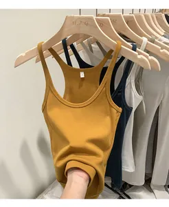 Detail view of mustard yellow ribbed knit tank top showing stretch and texture.
