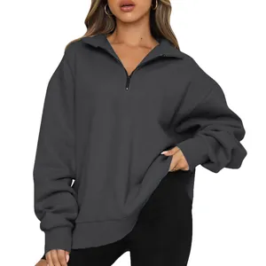 Detail of women's grey half-zip long sleeve sweatshirt with ribbed cuffs and loose fit