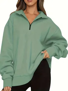 Detailed view of women's sage green half-zip pullover sweatshirt with black zipper