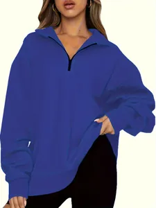 Close-up of a blue half-zip pullover sweatshirt with a relaxed fit for women's autumn