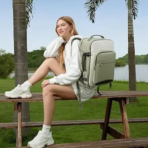 Large olive green and white two-tone travel backpack shown in outdoor lifestyle setting