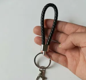 Detail view of a black braided PU leather keychain with a sturdy silver metal ring