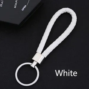 Detailed macro view of white braided PU leather strap keychain with silver metal ring