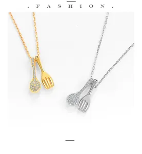 Detailed view of S925 silver spoon and fork necklaces with pavé stones in two colors.