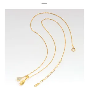 Close-up detail of a gold S925 sterling silver necklace with spoon and fork pendant