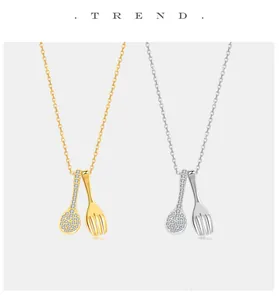 Detailed view of S925 sterling silver spoon and fork necklace with pavé stones
