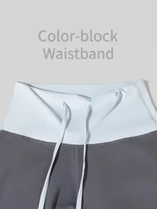 High-waisted yoga sweatpants with contrast color waistband and adjustable drawstring