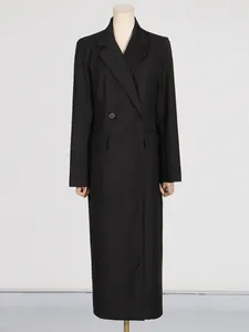 Elegant women's long black slim-fit trench coat featuring a double-breasted style.