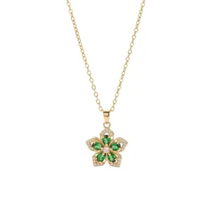 Gold-tone rotating flower pendant necklace with green zircons and clear crystals