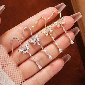 Detailed close-up of sweet butterfly tassel earrings with sparkling moissanite stones