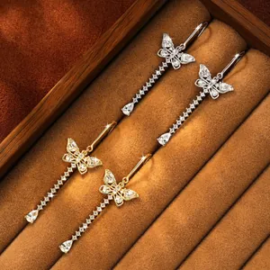Detailed view of elegant butterfly tassel earrings with sparkling moissanite stones