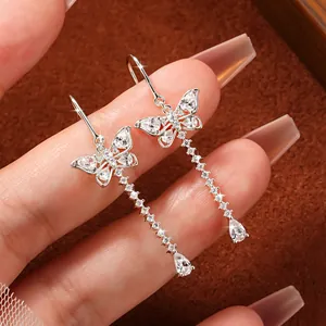 Detailed view of silver butterfly tassel earrings featuring sparkling moissanite stones.