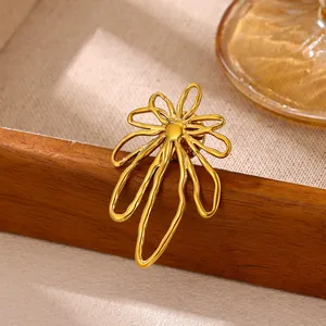 Detail view of abstract gold sunflower brooch on rustic wooden background texture