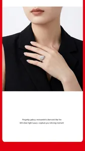 Elegant S925 silver moissanite halo ring with brilliant fire shown on model hand