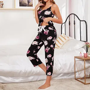 Two-piece women's floral pajama set featuring rose print camisole and long pants