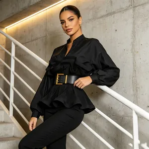 Detailed view of women's black pleated ruffle shirt with elegant wide gold buckle belt