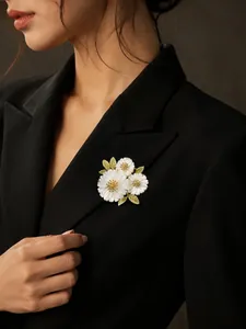 Close-up of elegant white daisy floral brooch pinned on a stylish black blazer lapel