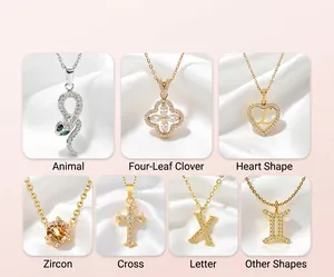 Collection of gold and silver pendants including snake, clover, heart and cross motifs
