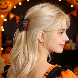 Detail of a sparkling black bat hair claw clip on blonde hair for Halloween party