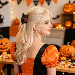 Detail view of a blonde model wearing a festive black bat hair claw clip for Halloween
