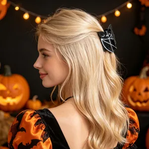 Detailed view of a black bat hair claw clip styled on long blonde hair for Halloween party.
