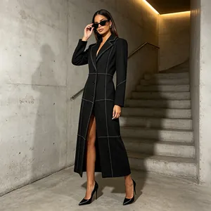 Elegant black long coat with minimalist white contrast stitching and slim fit silhouette.