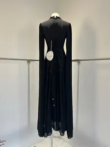 Detail van zwarte avondjurk met vetersluiting aan de achterkant en cape-mouwen