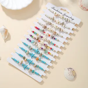 Close-up detail of handmade bohemian shell and starfish braided bracelet set on card