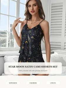 Detail view of navy satin loungewear set featuring golden star and moon prints with cami top